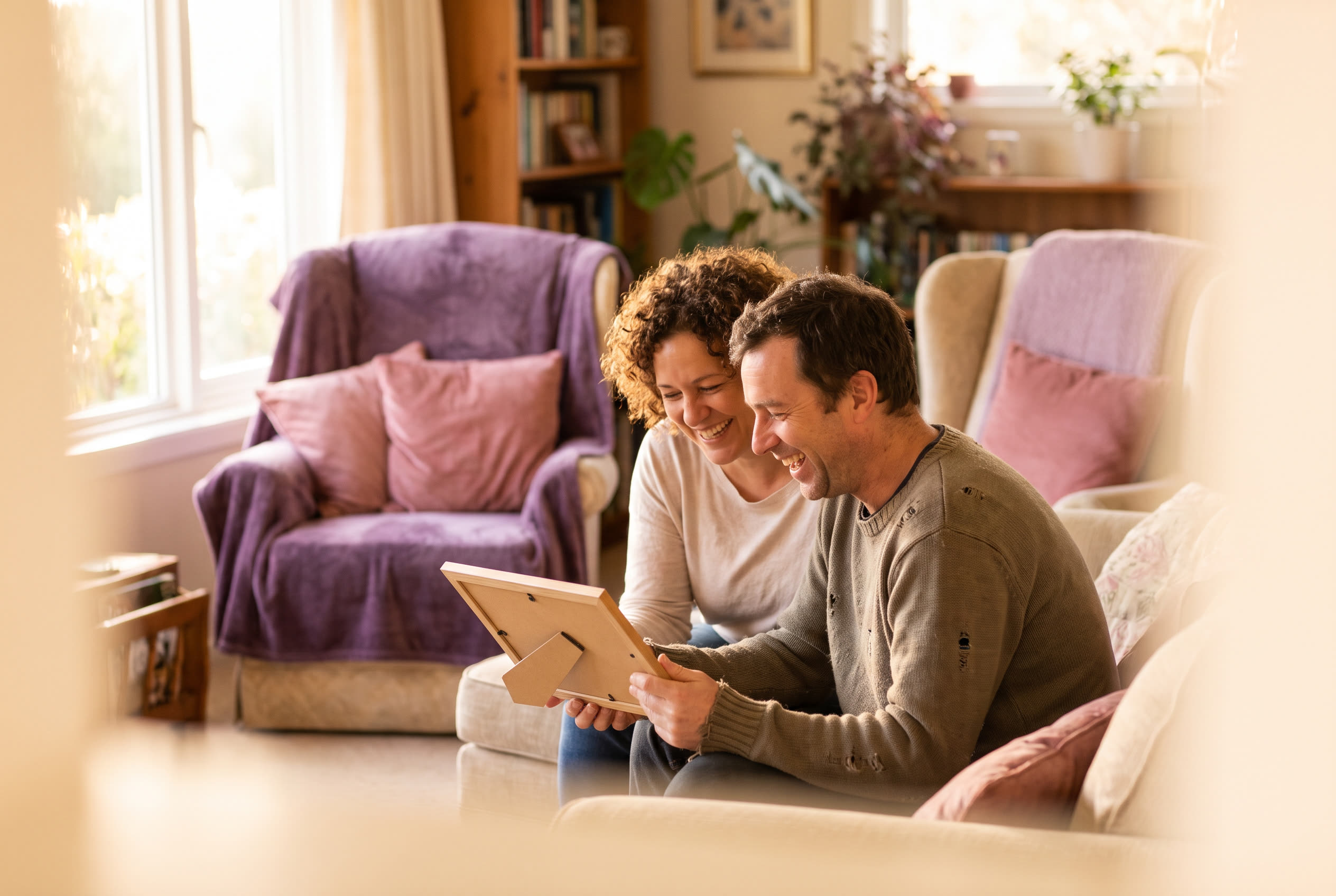 A person and their dad sharing a joyful father's day moment at home