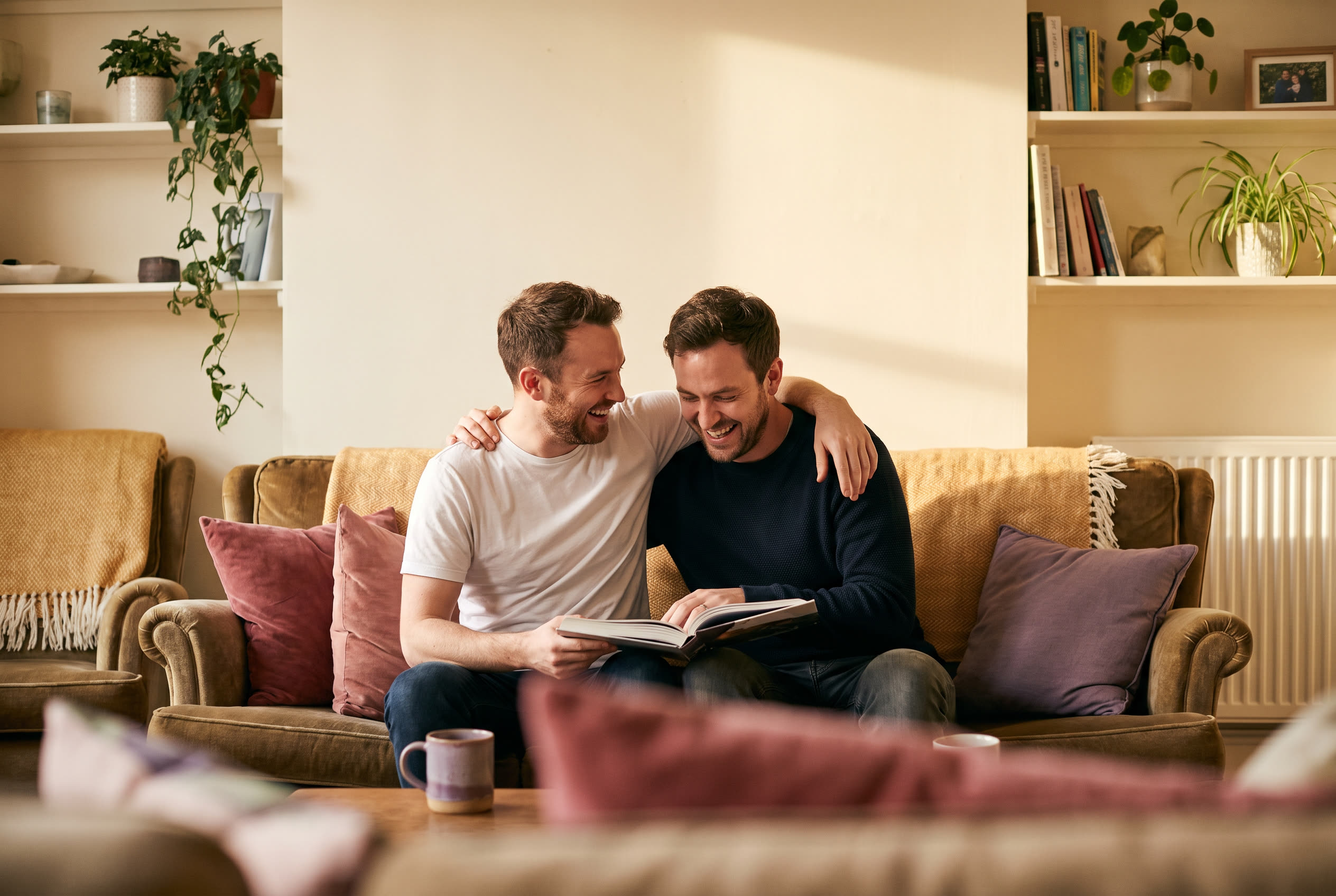 A person and their brother sharing a warm everyday moment at home, genuine affection, no special occasion