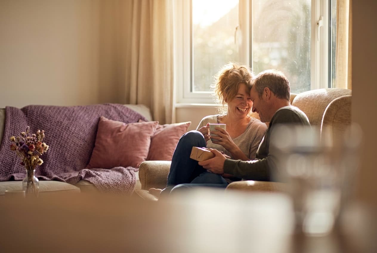 A person and their wife sharing a joyful valentine's day moment at home