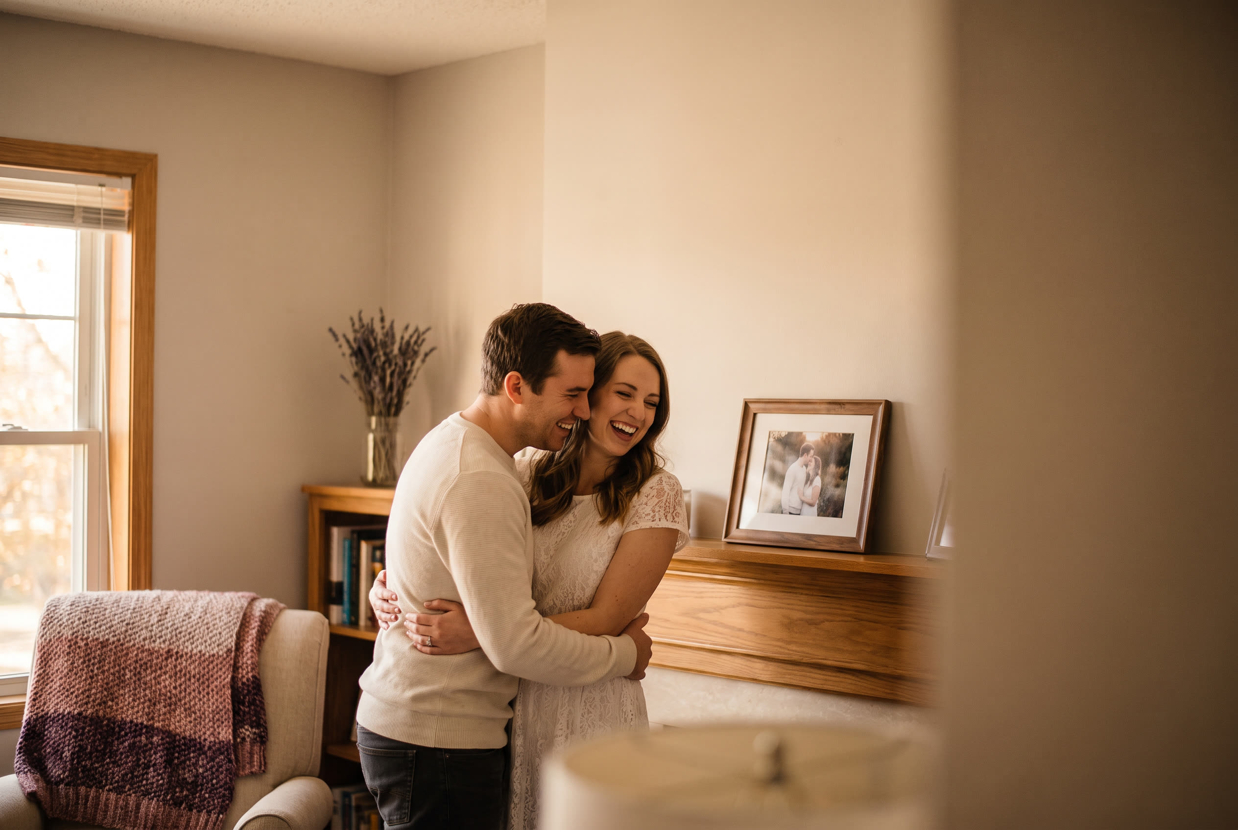 A person and their girlfriend sharing a joyful wedding moment at home